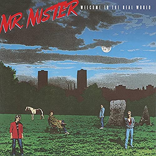 Album cover for Mr. Mister’s “Welcome To The Real World” with band and cityscape.