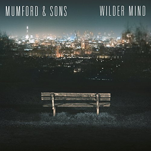 Album cover: bench facing a blurred, illuminated cityscape at dusk.