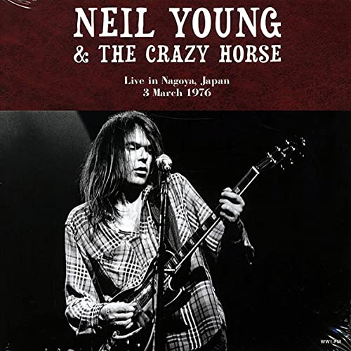 Neil Young playing guitar live on stage, album cover art.
