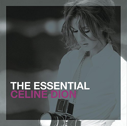 Celine Dion holding a camera on the cover of her album The Essential.