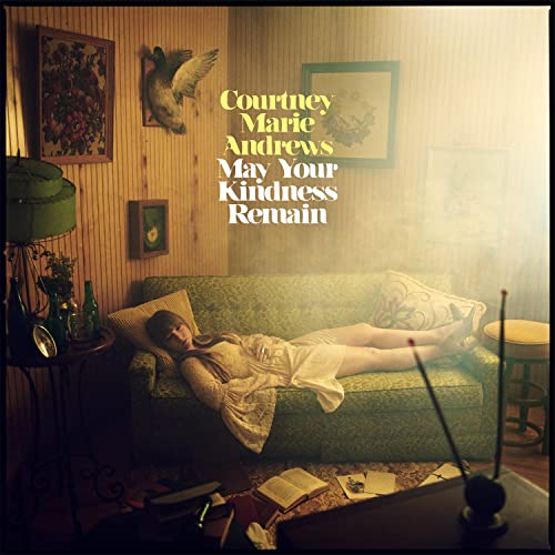 Album cover: woman reclining on a couch in a vintage room.