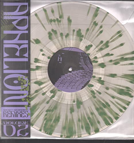 Transparent vinyl record with green splatter, featuring geometric artwork.