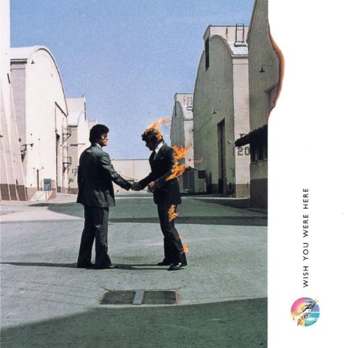 Two men in suits shaking hands, one engulfed in flames.