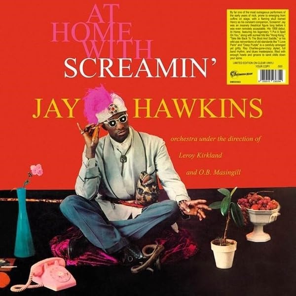 Screamin’ Jay Hawkins album cover, seated artist with vibrant props, red background.
