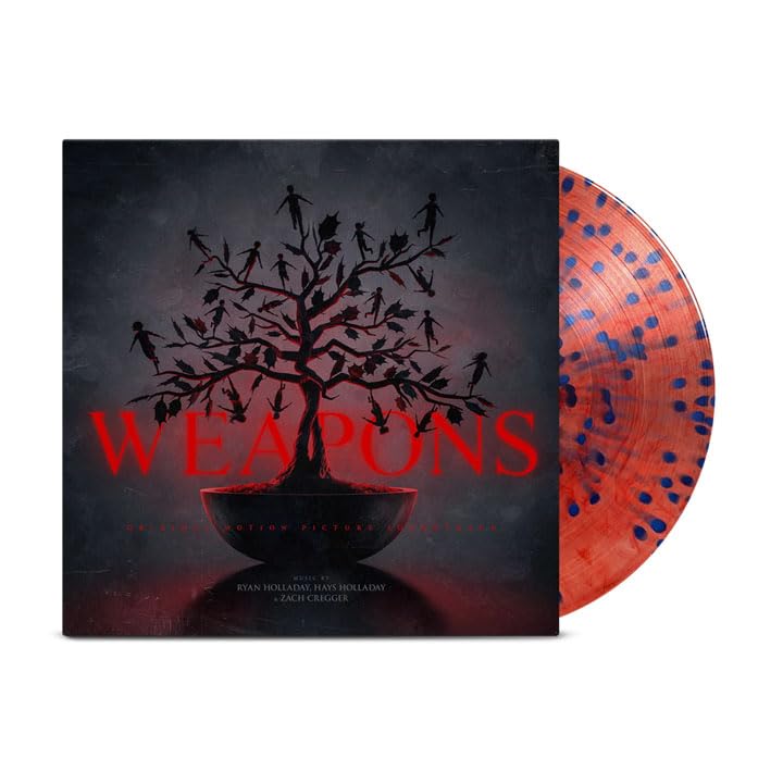Vinyl record with a dark tree silhouette and orange-splattered side.