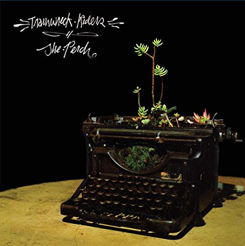 Black CD cover with a vintage typewriter holding succulents.