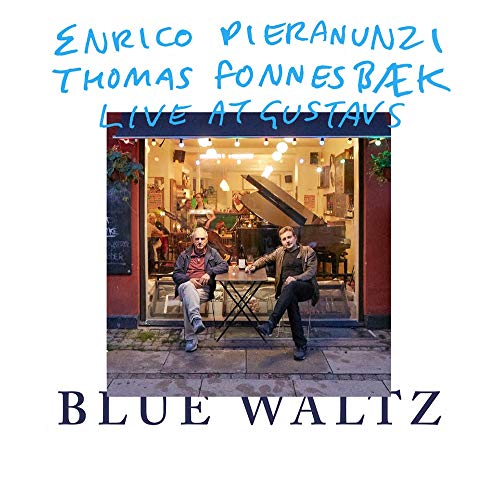 CD cover featuring two men seated in front of a piano and cafe.