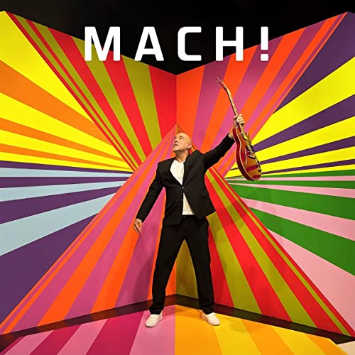 CD cover featuring a man in a suit against a colorful, radial background.
