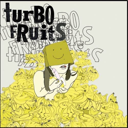 A person with a paper bag over their head sits in a pile of bananas.