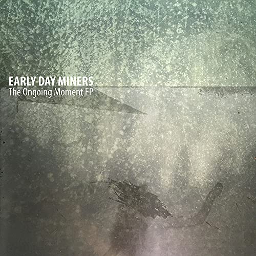 Vinyl record cover for Early Day Miners’ “The Ongoing Moment EP,” textured gray.