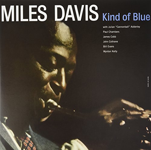 Miles Davis’ “Kind of Blue” vinyl album cover, portrait of Davis playing trumpet.