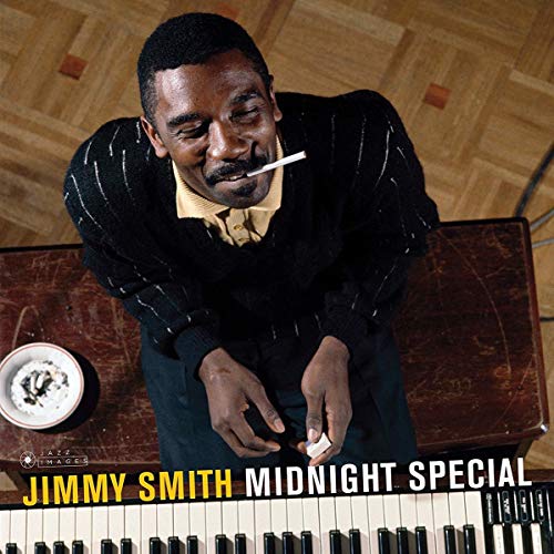 Jimmy Smith at an organ, smoking, album cover art by Leloir.