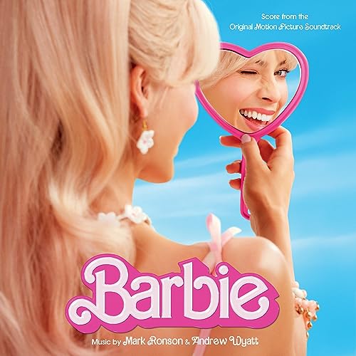 Blonde woman looking at her reflection in a pink heart-shaped mirror with Barbie text.