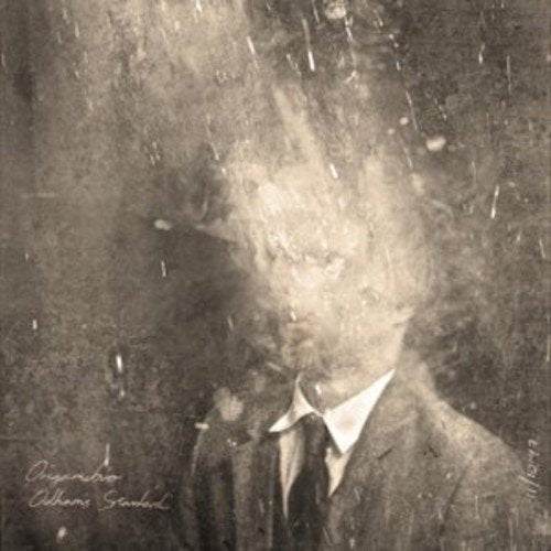Distorted portrait of a man in a suit, with abstract, grainy texture.