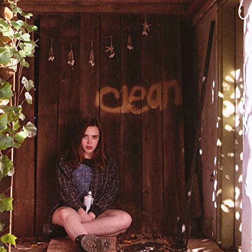 Soccer Mommy album cover, woman sitting in a wooden doorway.