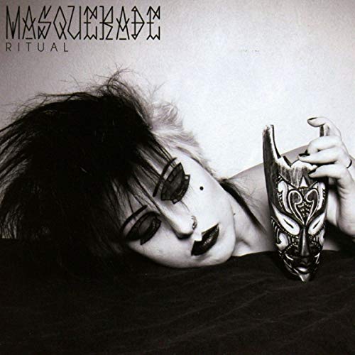 Black and white album cover featuring a person and a decorative mask.