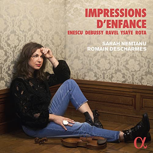 Woman with violin sits against patterned wall, CD cover art.