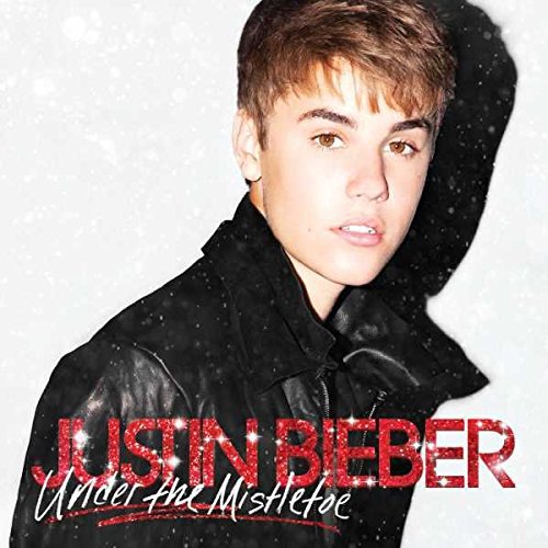 Justin Bieber album cover, "Under The Mistletoe," with falling snowflakes.