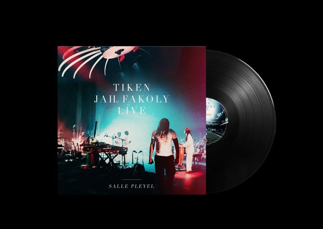 Vinyl record cover featuring a musician performing on stage, dark blue background.