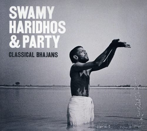 CD cover featuring a man with raised arms in a river.