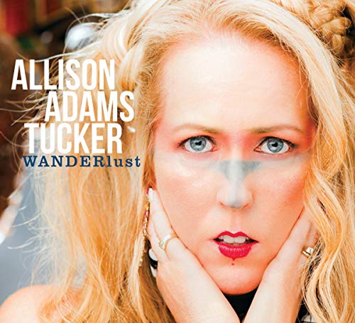 CD cover featuring blonde woman with painted face, "Wanderlust" text.