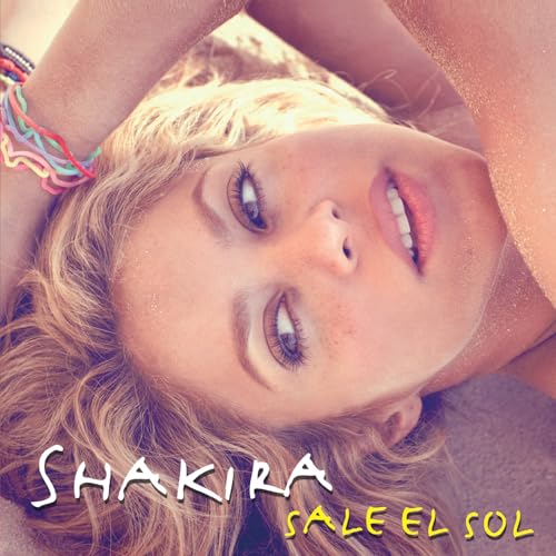 Shakiraâs album cover, close-up of her face with blonde hair, sunlit.