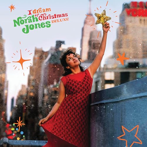 Norah Jones album cover featuring a woman reaching for a star, New York skyline.