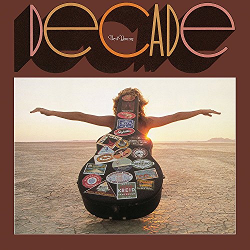 Album cover for Neil Youngās āDecadeā featuring a person with a guitar case.