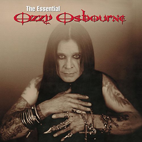 Portrait of Ozzy Osbourne with long dark hair, tattoos, and jewelry on a background.