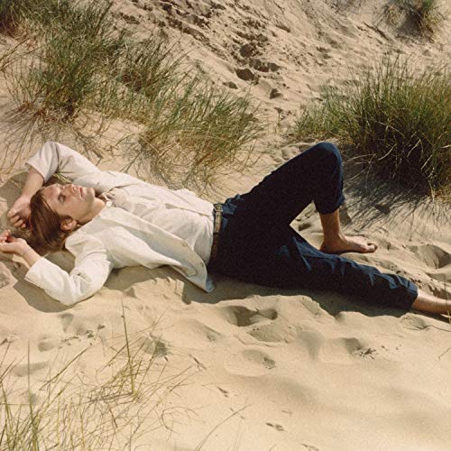 Man lying in sand dunes, album cover for Jaakko Eino Kalevi.