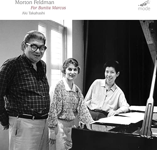 CD cover featuring three people with a piano, black and white photo.