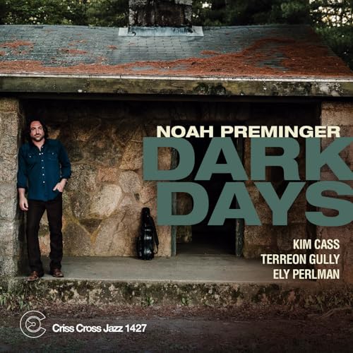 CD cover: man standing in front of a stone building.