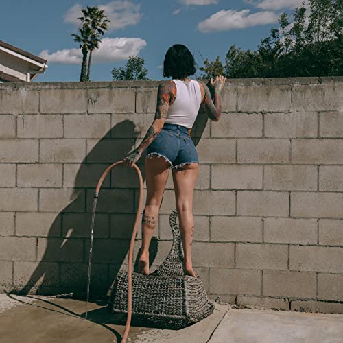 Kehlani album cover: woman with tattoos standing by a wall.