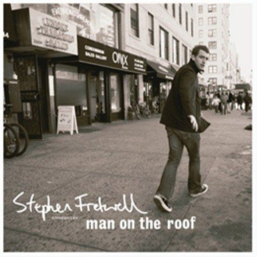CD cover: Man walking on a city street, album title below.