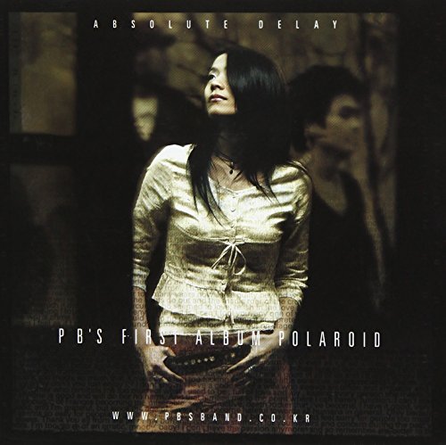 CD cover for “Polaroid” featuring a woman looking upwards, dark background.