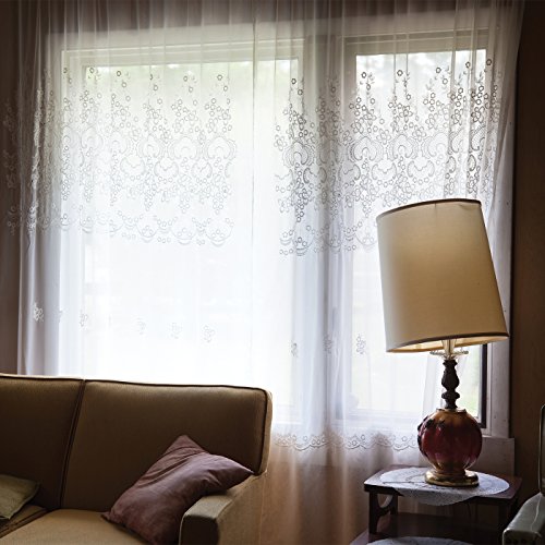CD case shown near a window with patterned curtains and a lamp.