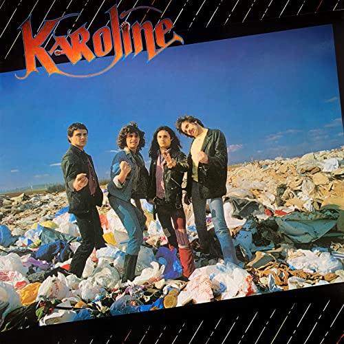 Band Karoline posing in front of a large, sprawling landfill.
