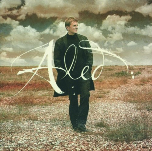 Aled Jones album cover: man in black coat, cloudy sky, script logo.