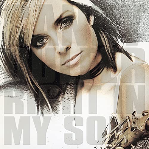 Close-up of Candy Dulfer with saxophone, album cover art.