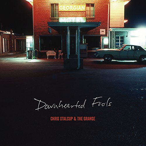 CD cover: a brick building at night with a vintage car.