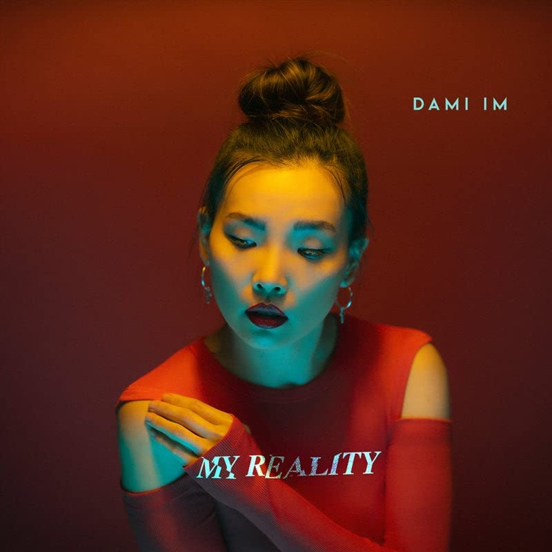Dami Im album cover, portrait with red and blue lighting.