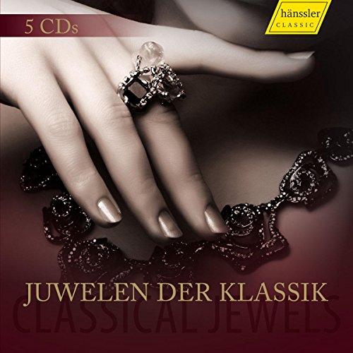 Five classical music CDs with a hand adorned with jewelry.