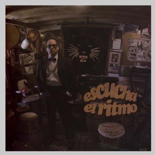 CD cover: man in suit, panther logo, and drums in a studio.
