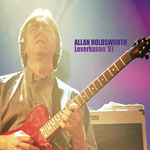 Allan Holdsworth playing a red guitar on the album cover, “Leverkusen ‘97”.