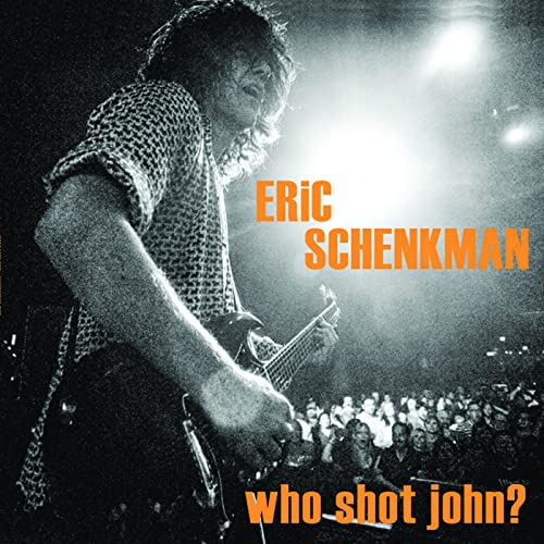 Eric Schenkman album cover featuring a guitarist playing onstage.