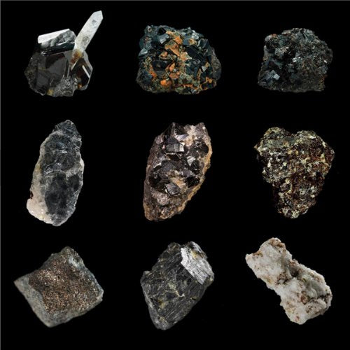 Black and gray coltan mineral samples arranged on a dark background.