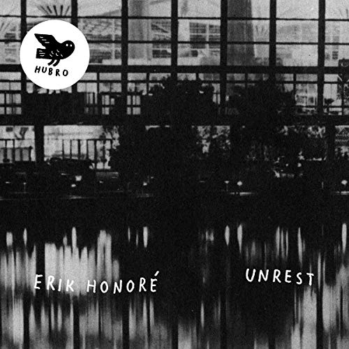 CD cover for "Unrest" by Erik Honoré, with a blurred building image.