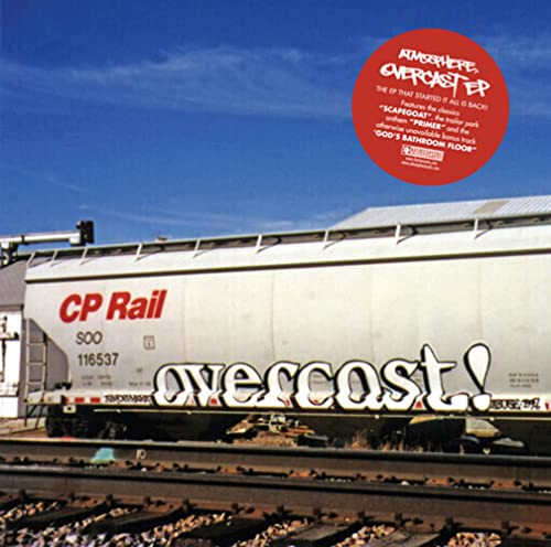 CD cover with graffiti-style text on a railcar against a blue sky.
