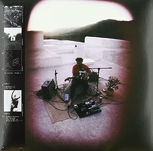 Vinyl album cover featuring a musician playing guitar on a rooftop.