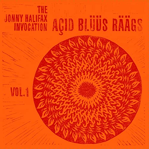 Orange vinyl record cover with a red, sun-like floral mandala.